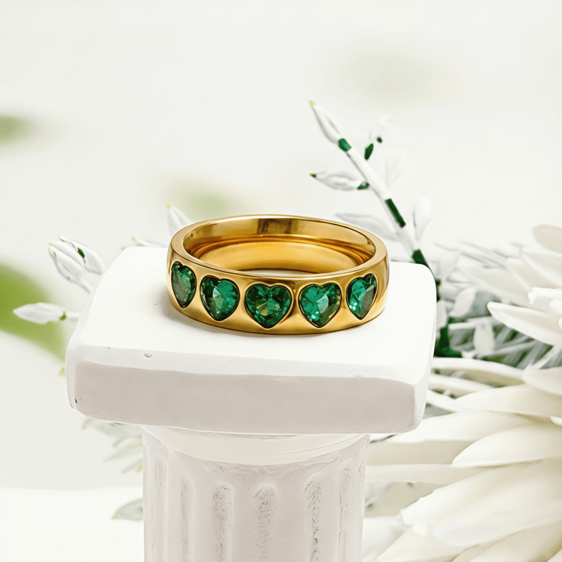 Gold Emerald Green Heart Ring by MXW Jewellery featuring a chunky gold band with flush-set emerald-hued heart stones