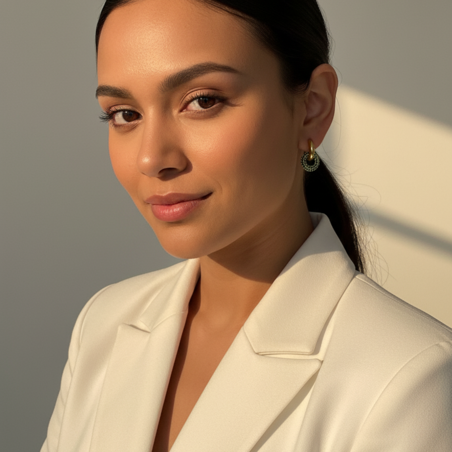 gold emerald pavé drop earrings with crystal halo circle hanging from gold huggies