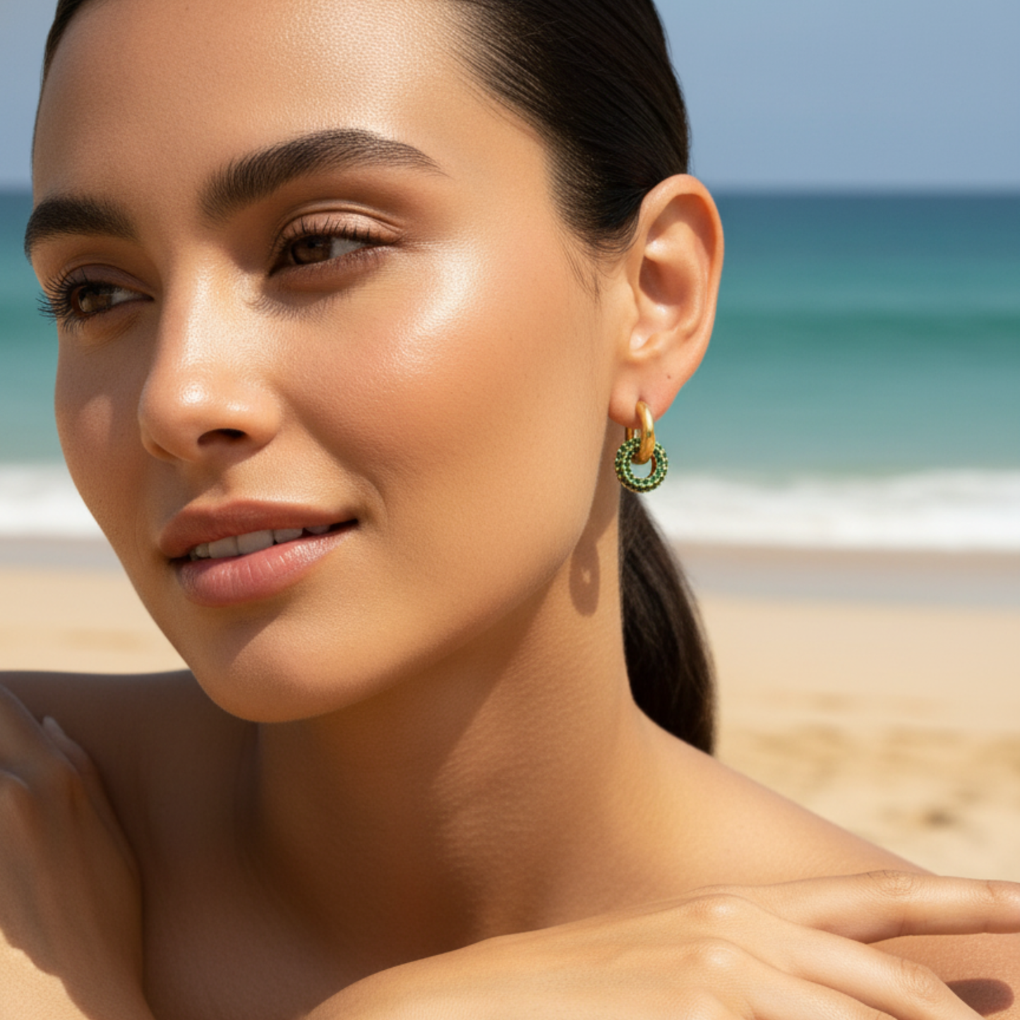 gold emerald pavé drop earrings with crystal halo circle hanging from gold huggies