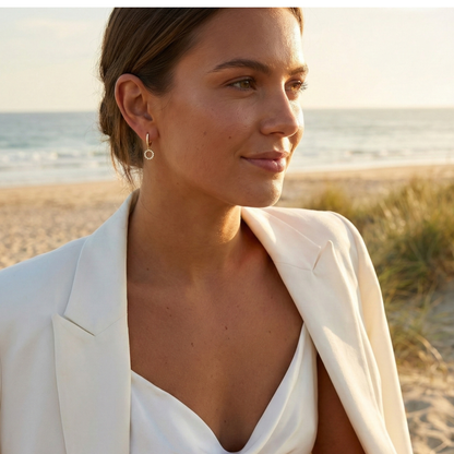 Gold huggie earrings featuring a pave crystal open circle charm dangling from a crystal hoop by MXW Jewellery