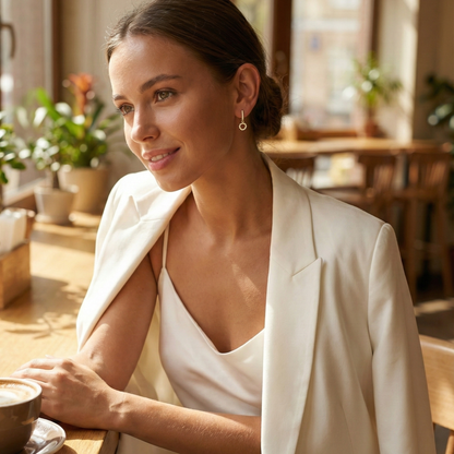 Gold huggie earrings featuring a pave crystal open circle charm dangling from a crystal hoop by MXW Jewellery