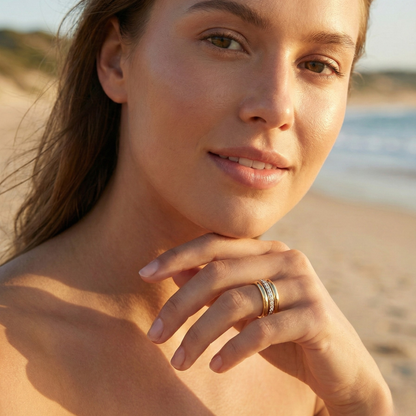 Close up of Gold Eternity Trio Stacking Ring Set by MXW Jewellery featuring a central crystal band nestled between two smooth gold bands.