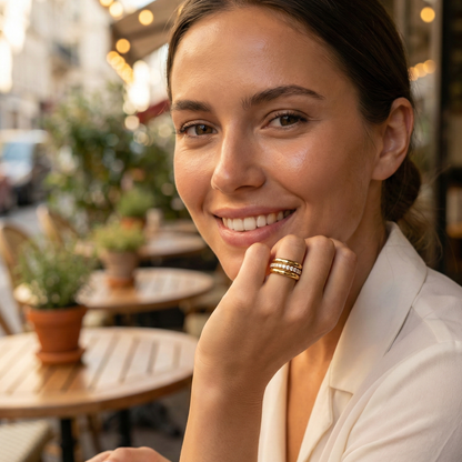Close up of Gold Eternity Trio Stacking Ring Set by MXW Jewellery featuring a central crystal band nestled between two smooth gold bands.