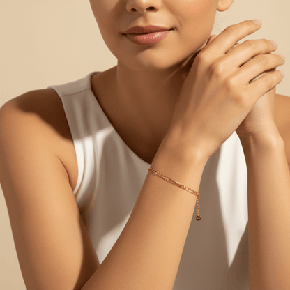 Gold Figaro link chain bracelet with polished elongated and short links.