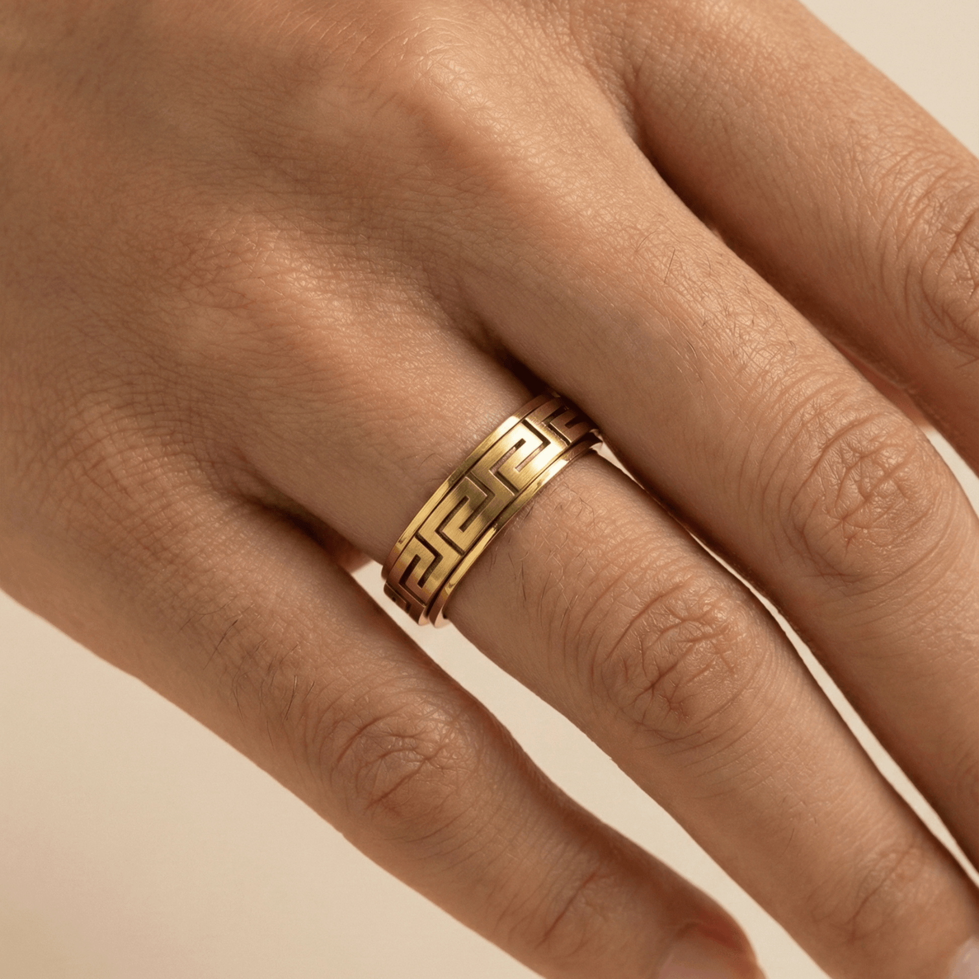 Gold Greek Key Spinner Ring by MXW Jewellery, featuring a rotating band with meander pattern for anxiety relief.