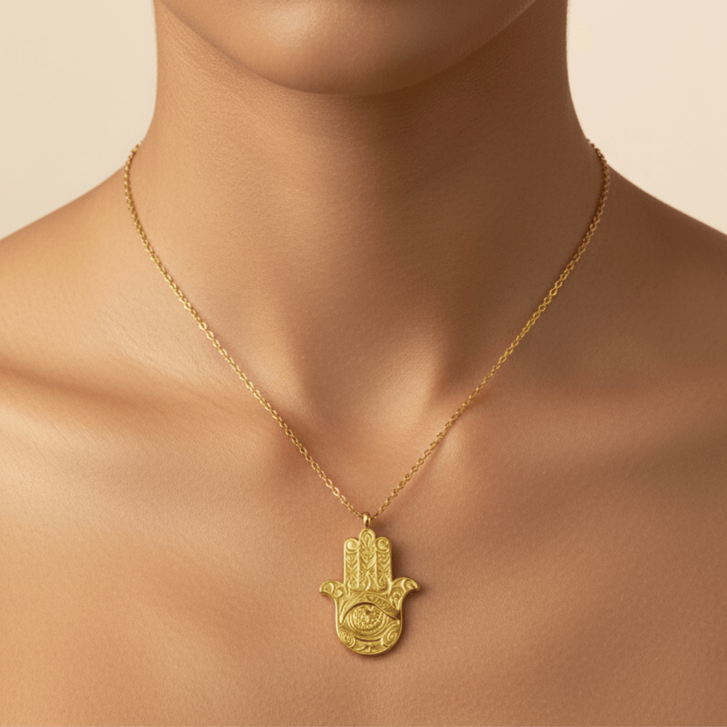 Gold Hamsa hand pendant necklace with engraved eye on a fine chain