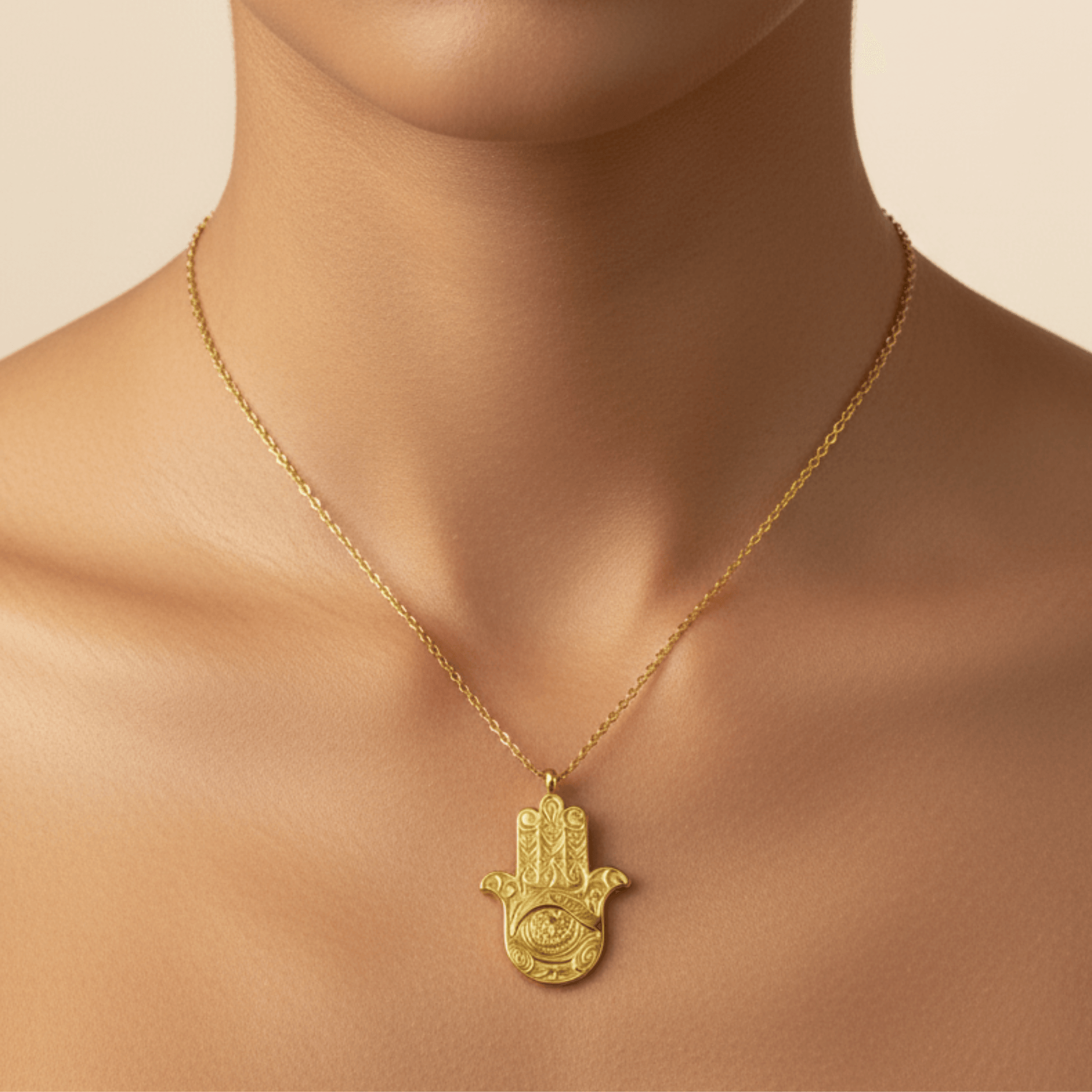 Gold Hamsa hand pendant necklace with engraved eye on a fine chain