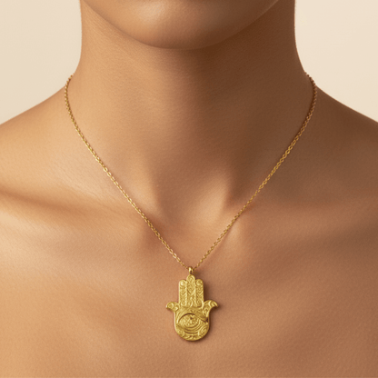 Gold Hamsa hand pendant necklace with engraved eye on a fine chain