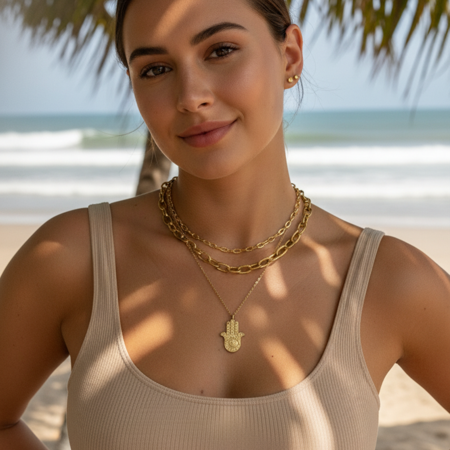 Gold Hamsa hand pendant necklace with engraved eye on a fine chain