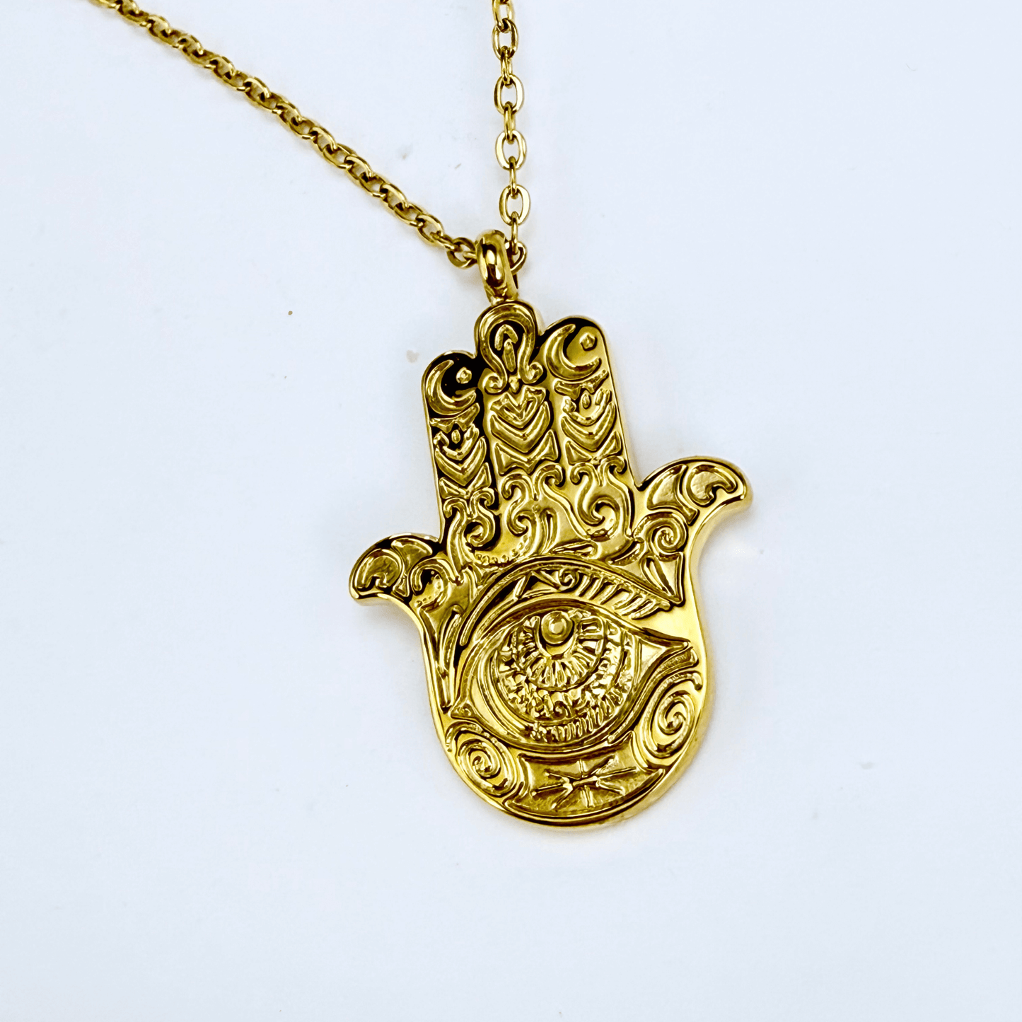 Gold Hamsa hand pendant necklace with engraved eye on a fine chain