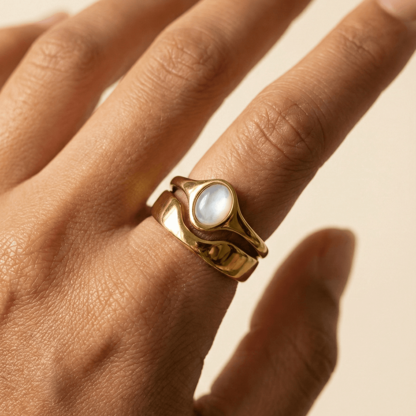 Gold Mother of Pearl Oval Signet Ring by MXW Jewellery, featuring a lustrous white stone and organic stacking design.
