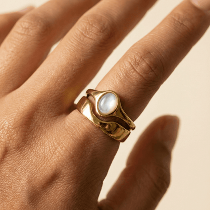 Gold Mother of Pearl Oval Signet Ring by MXW Jewellery, featuring a lustrous white stone and organic stacking design.