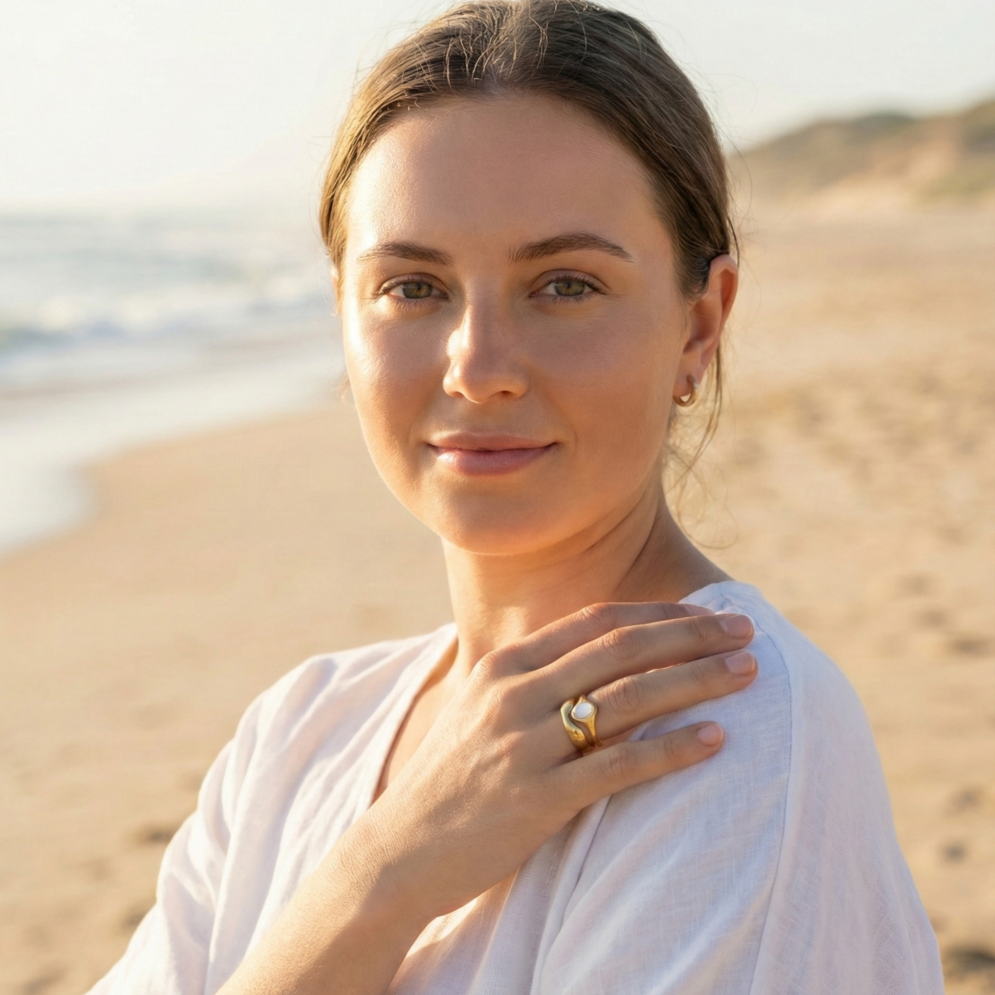 Gold Mother of Pearl Oval Signet Ring by MXW Jewellery, featuring a lustrous white stone and organic stacking design.