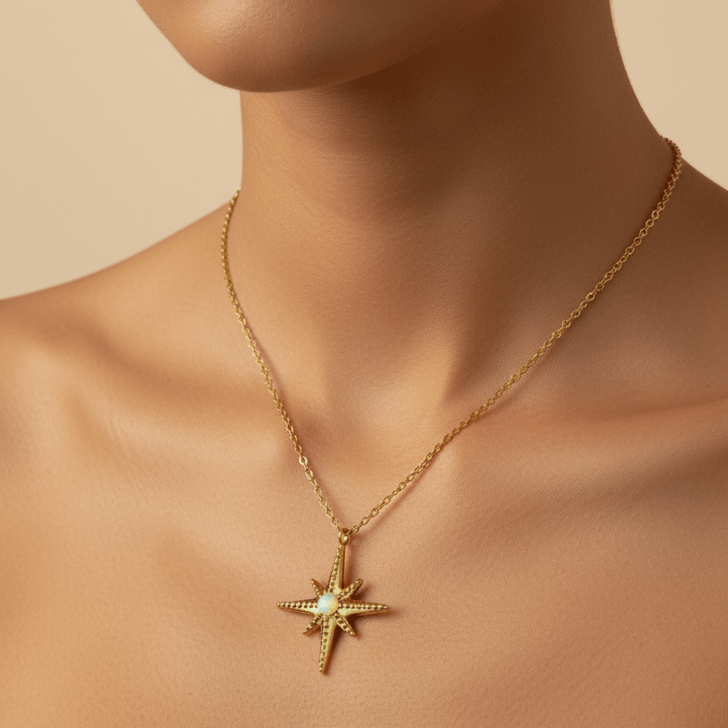 Gold North Star pendant necklace with luminous glass centre, symbolising guidance, balance, and hope.