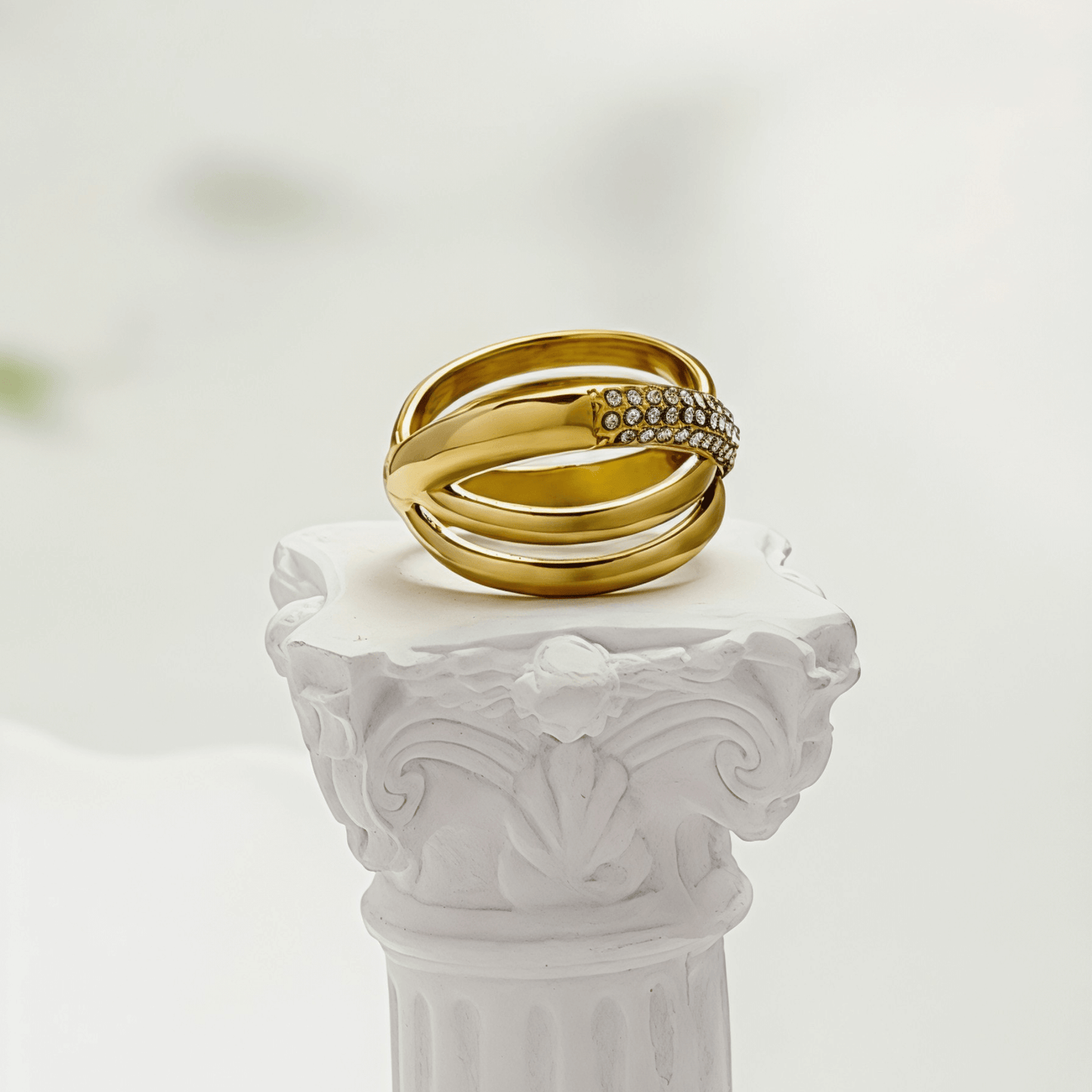 Gold Pave Crossover Ring by MXW Jewellery featuring intertwined gold bands and sparkling crystal pave details.