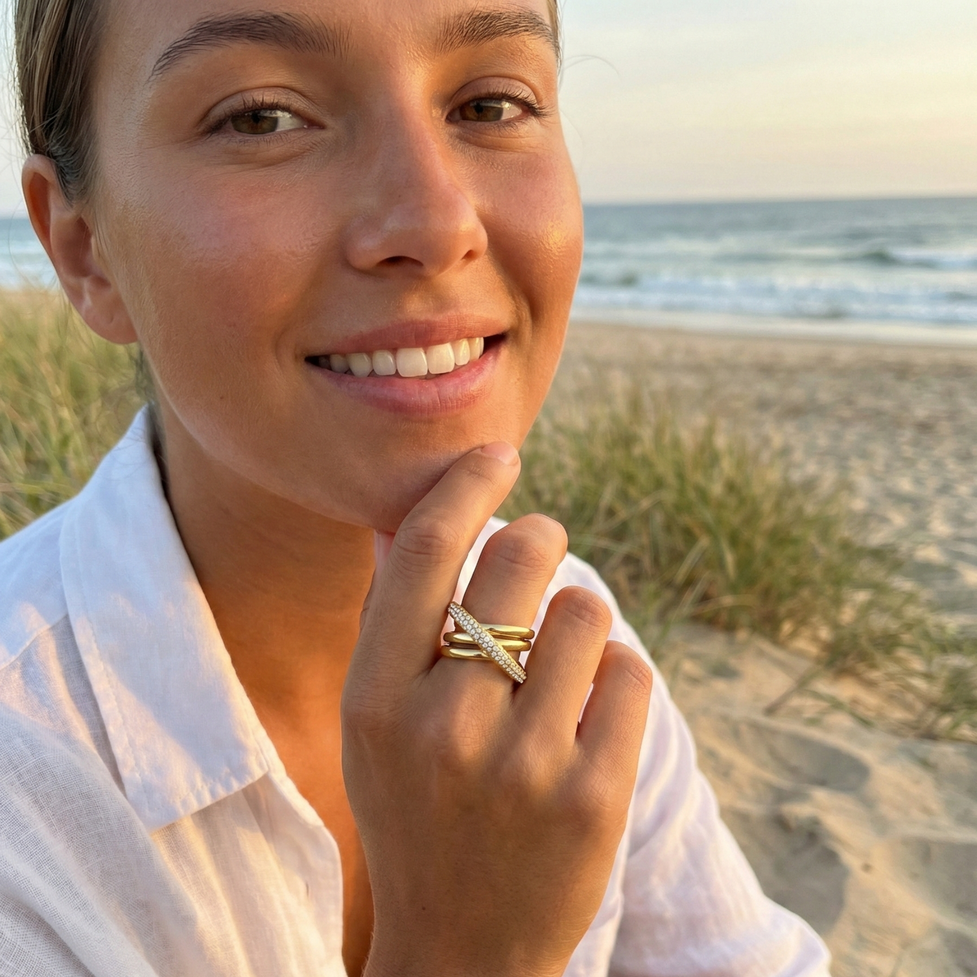 Gold Pave Crossover Ring by MXW Jewellery featuring intertwined gold bands and sparkling crystal pave details.