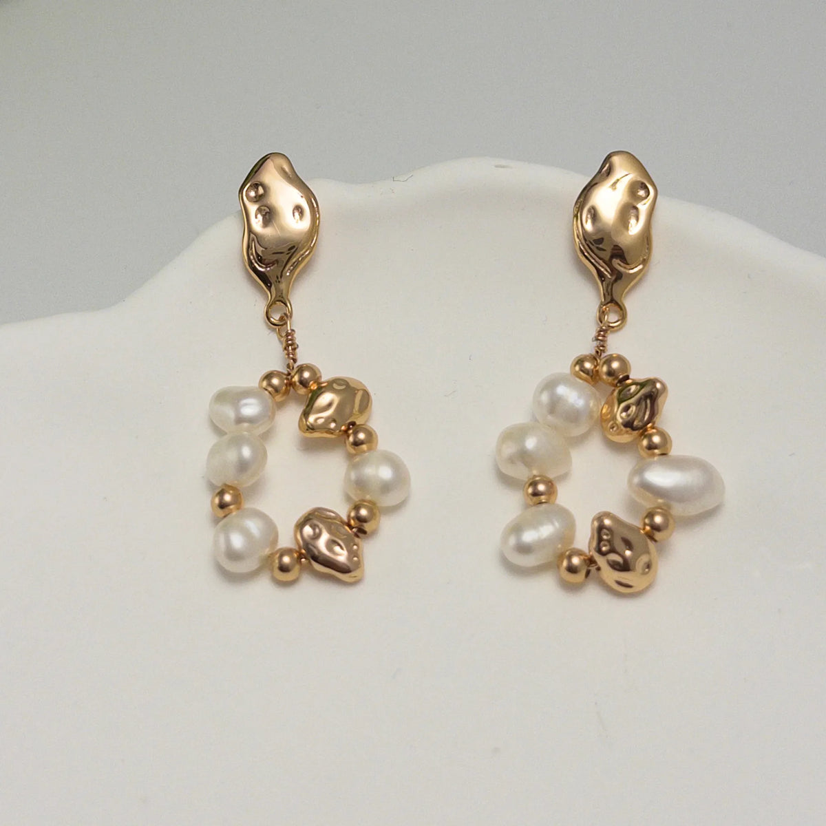 MXW Jewellery Gold vermeil drop earring with freshwater pearls, gold beads and hammered nuggets in an open loop below a textured stud