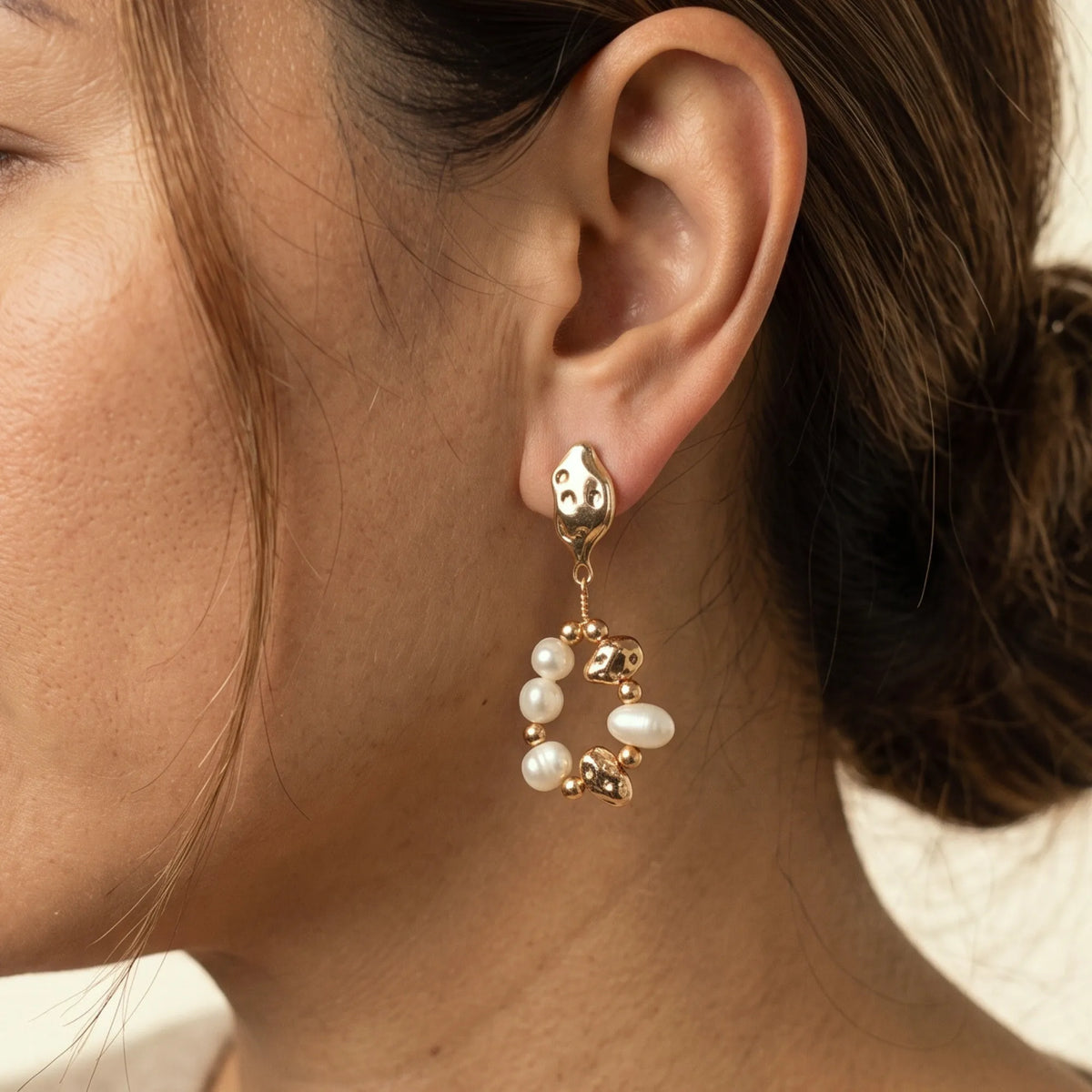MXW Jewellery Gold vermeil drop earring with freshwater pearls, gold beads and hammered nuggets in an open loop below a textured stud