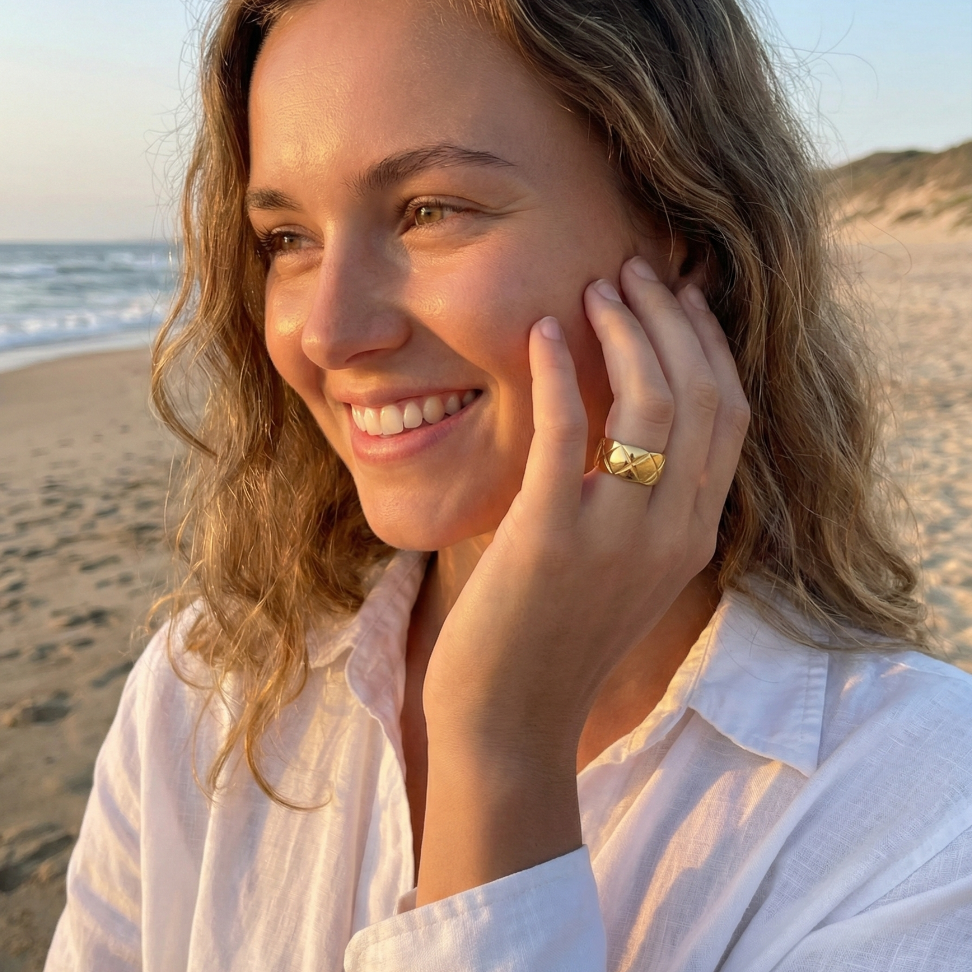 Quilted Gold Band Ring by MXW Jewellery, featuring a wide gold band with a geometric cross-hatch pattern on a white pedestal.