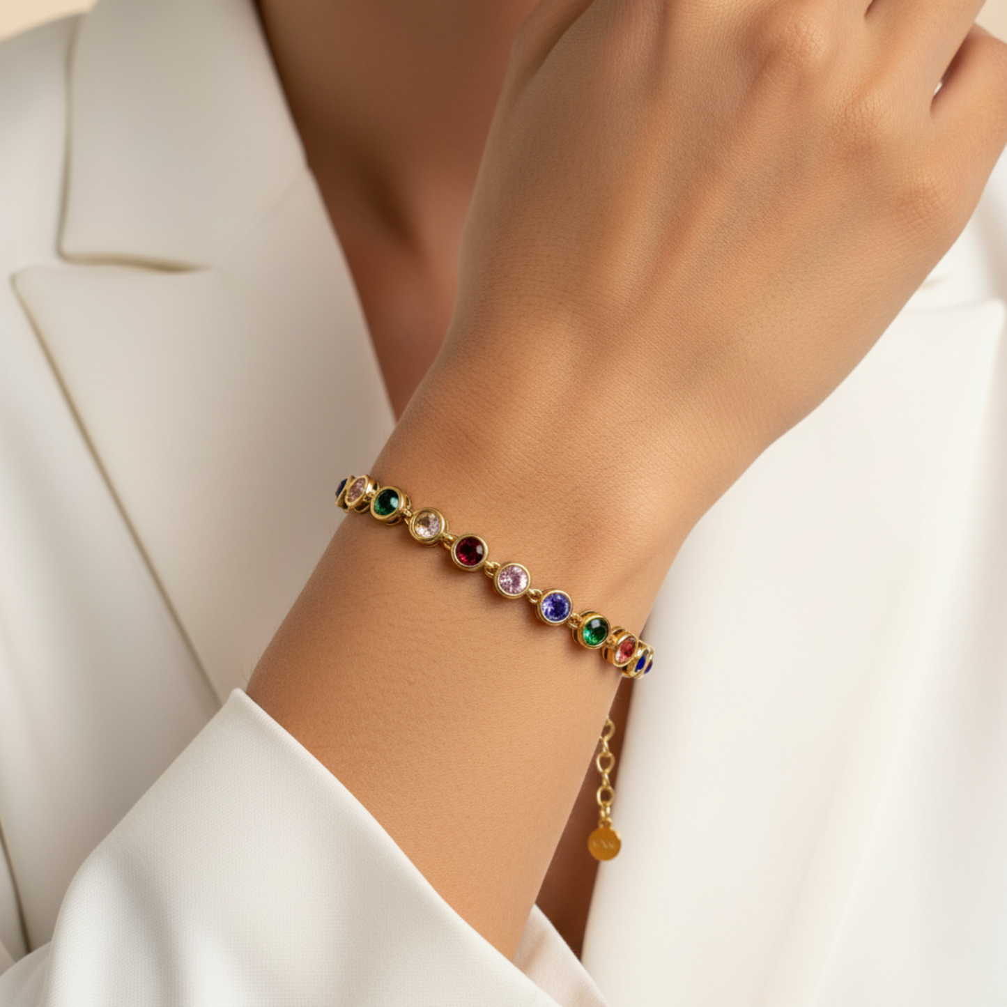 Gold rainbow crystal tennis bracelet with multi-coloured bezel-set stones.