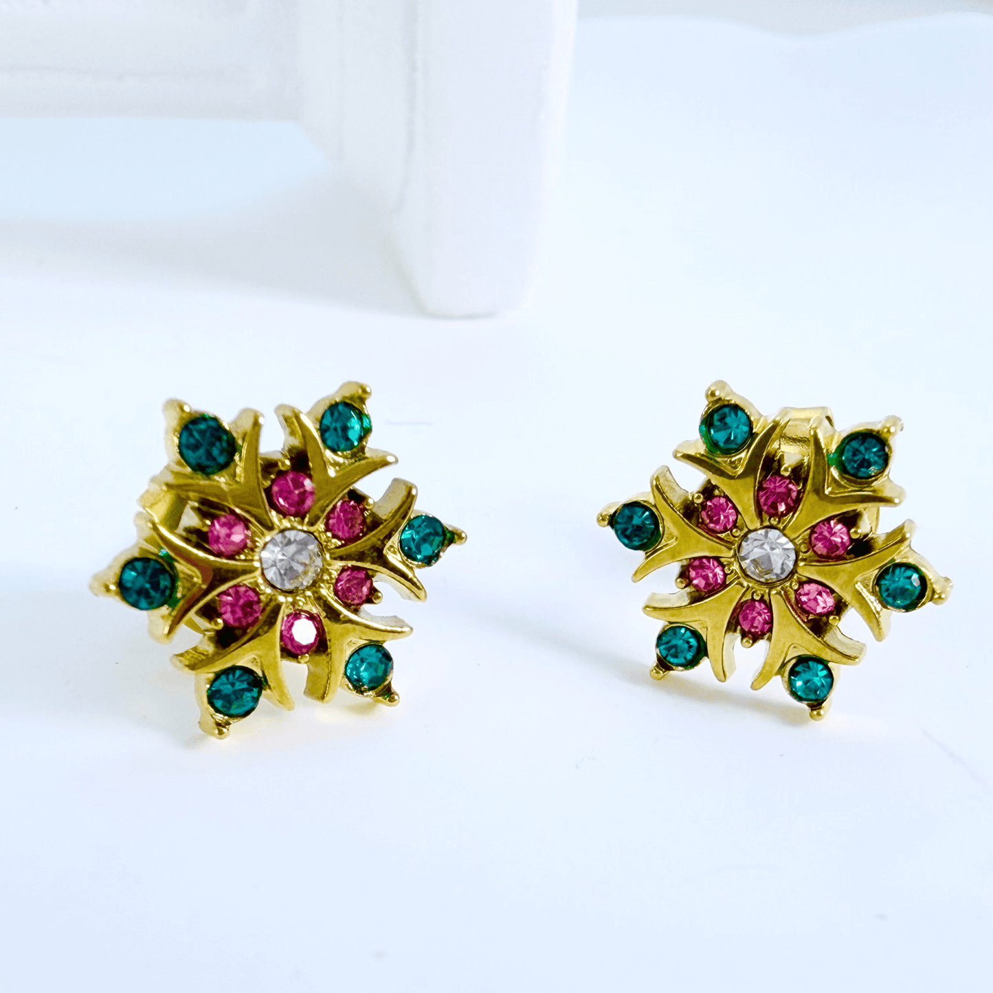 Gold rainbow sunburst crystal stud earrings with multicolour stones in a gold setting.