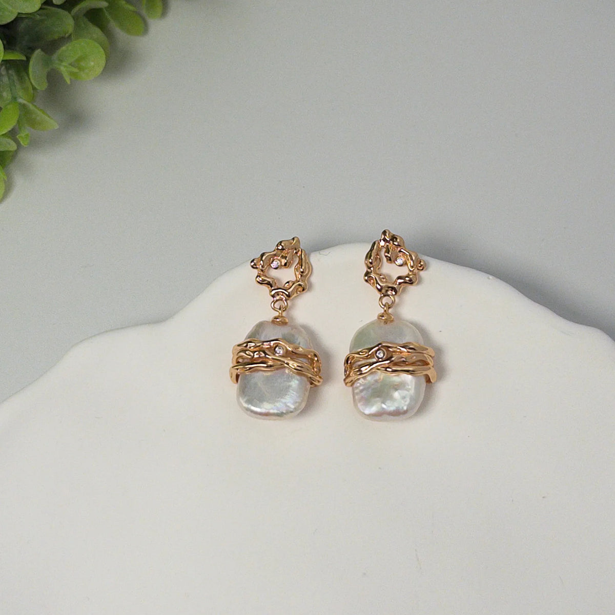 MXW Jewellery Gold vermeil drop earrings with a large baroque freshwater pearl wrapped in textured gold bands below an open molten stud