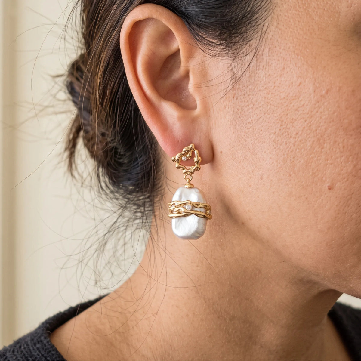 MXW Jewellery Gold vermeil drop earrings with a large baroque freshwater pearl wrapped in textured gold bands below an open molten stud