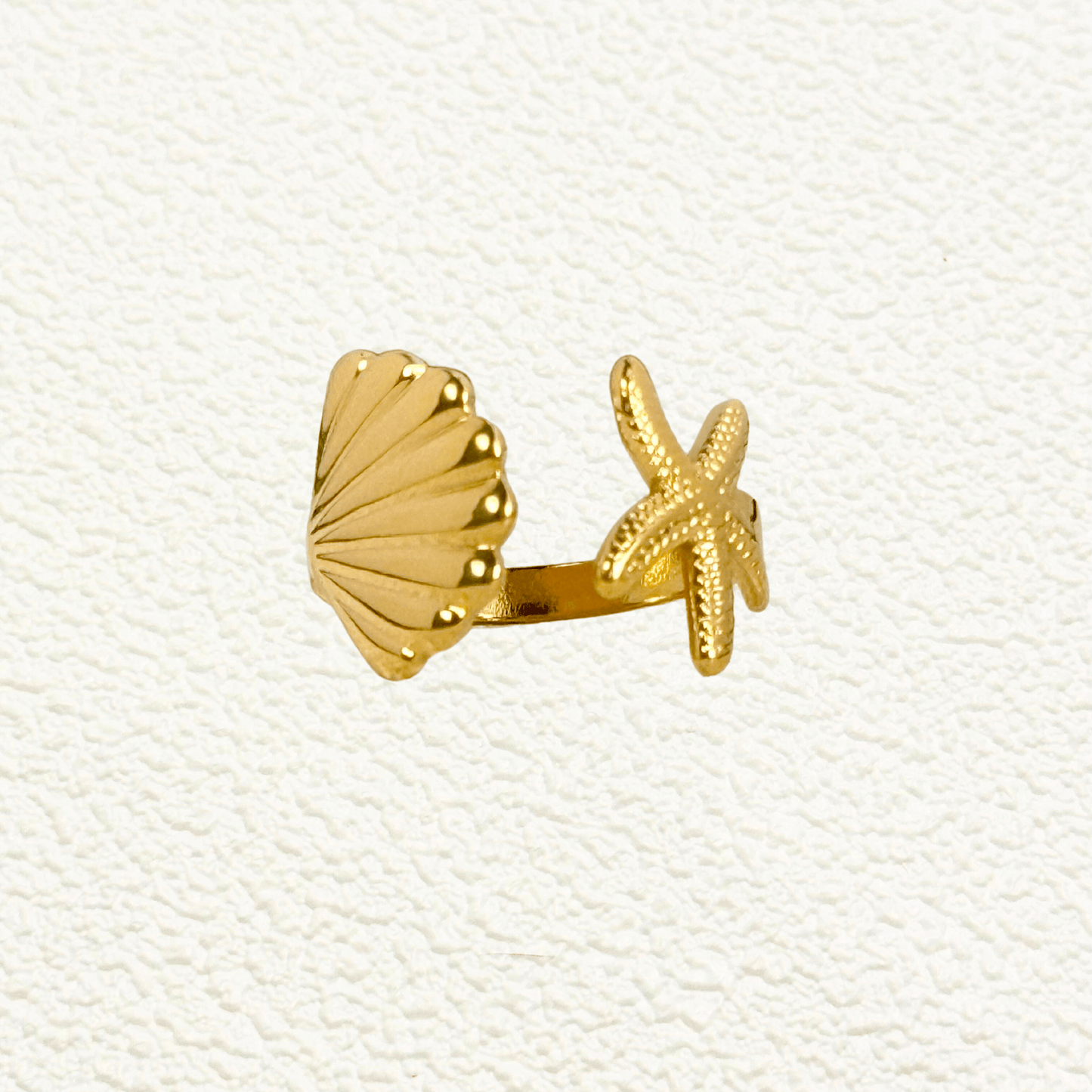 Gold adjustable seashell and starfish ring from MXW Jewellery, crafted in waterproof PVD gold stainless steel,
