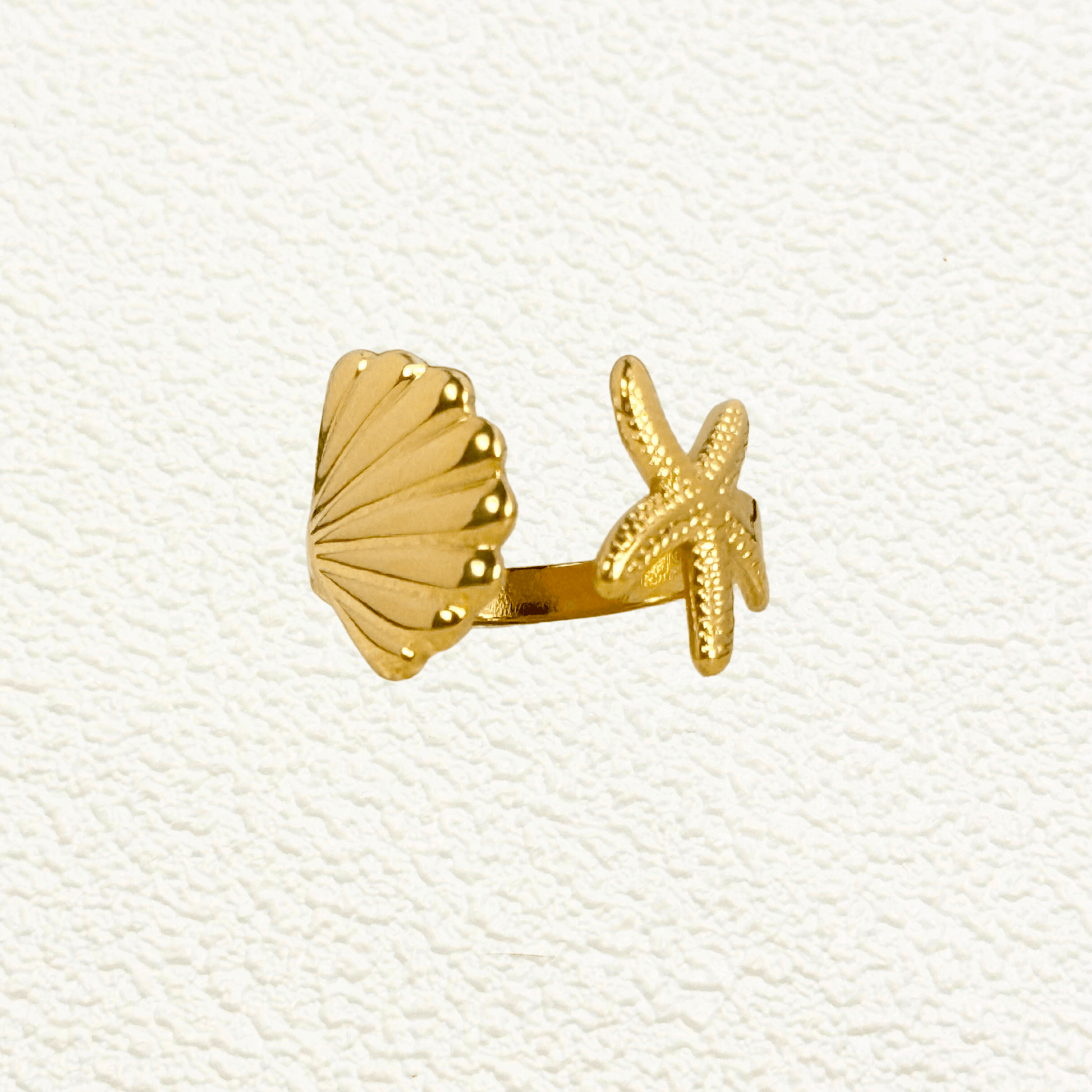 Gold adjustable seashell and starfish ring from MXW Jewellery, crafted in waterproof PVD gold stainless steel,