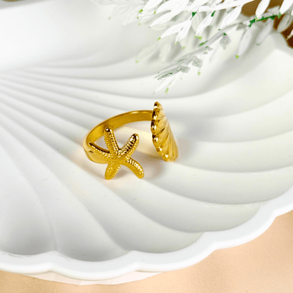 Gold adjustable seashell and starfish ring from MXW Jewellery, crafted in waterproof PVD gold stainless steel,