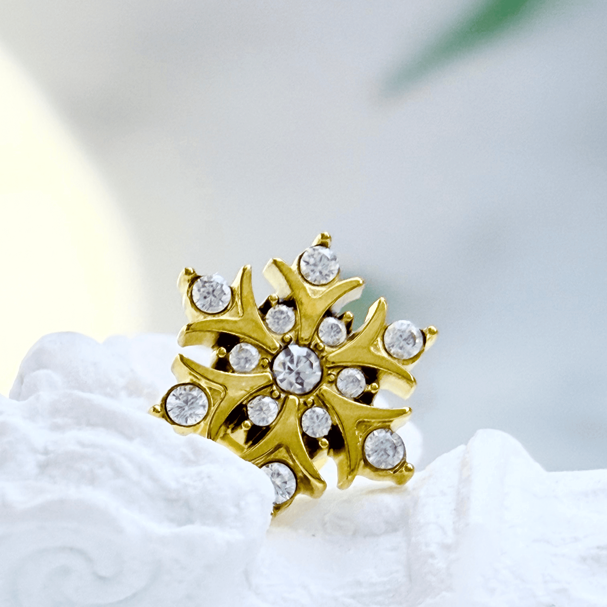 Gold sunburst crystal stud earrings with sparkling round crystals.