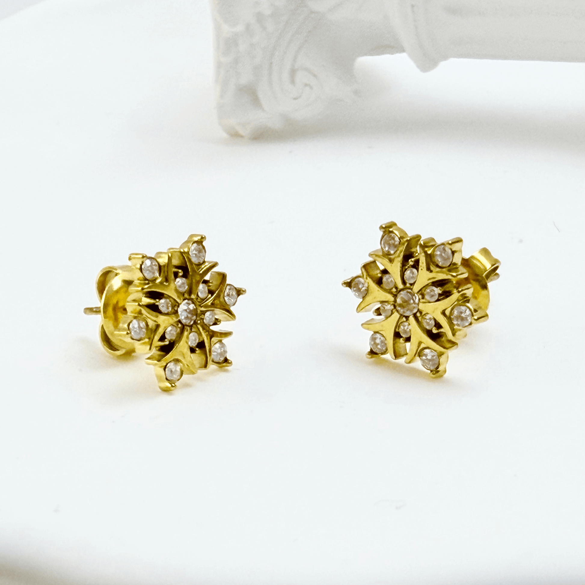 Gold sunburst crystal stud earrings with sparkling round crystals.