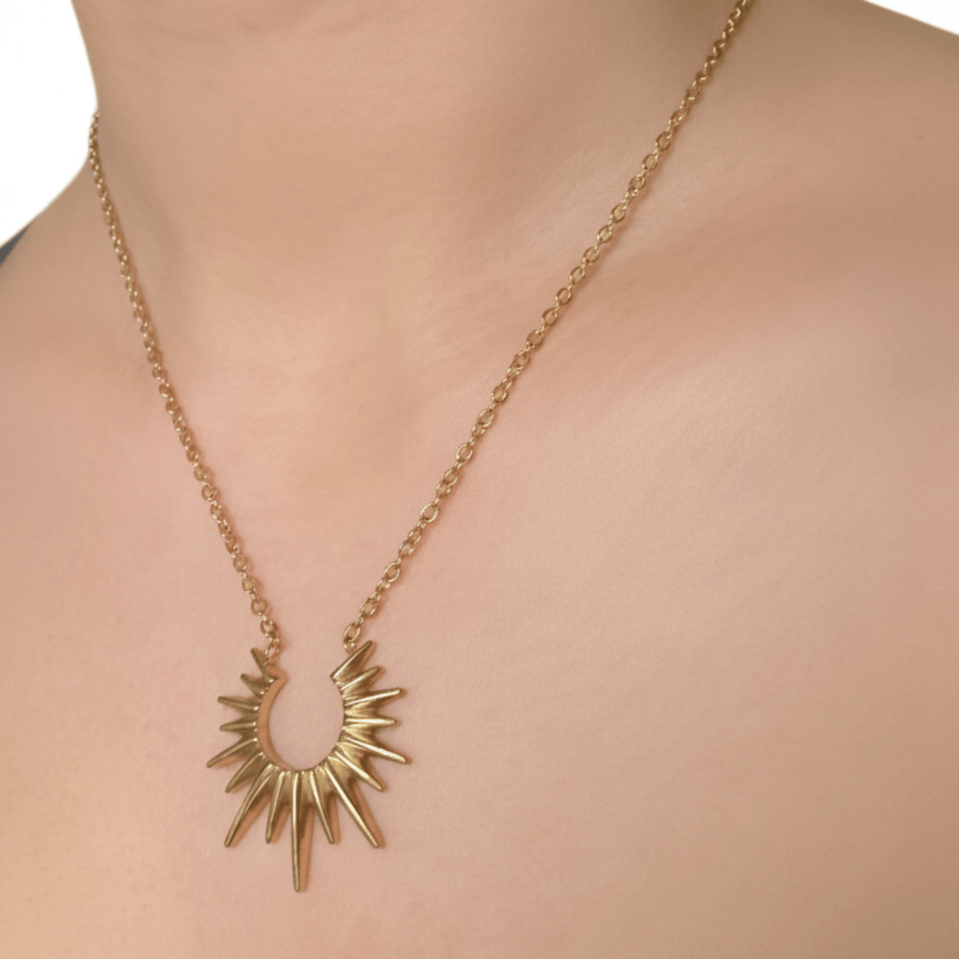 Waterproof gold sunburst necklace with radiant crescent pendant, crafted in 18K gold-plated stainless steel for an elegant celestial look.