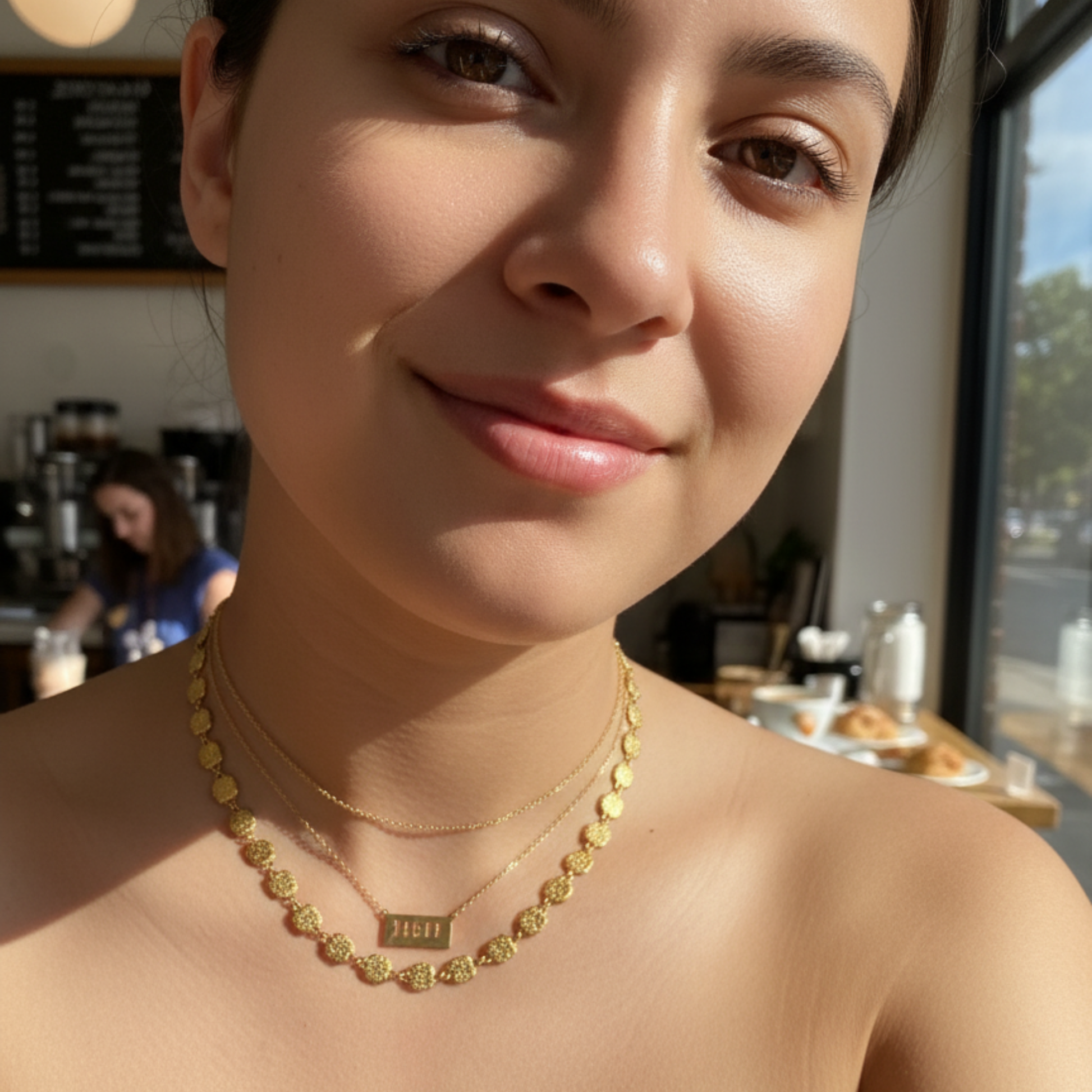 Gold textured square link chain necklace featuring small engraved square links connected in a continuous gold pattern.