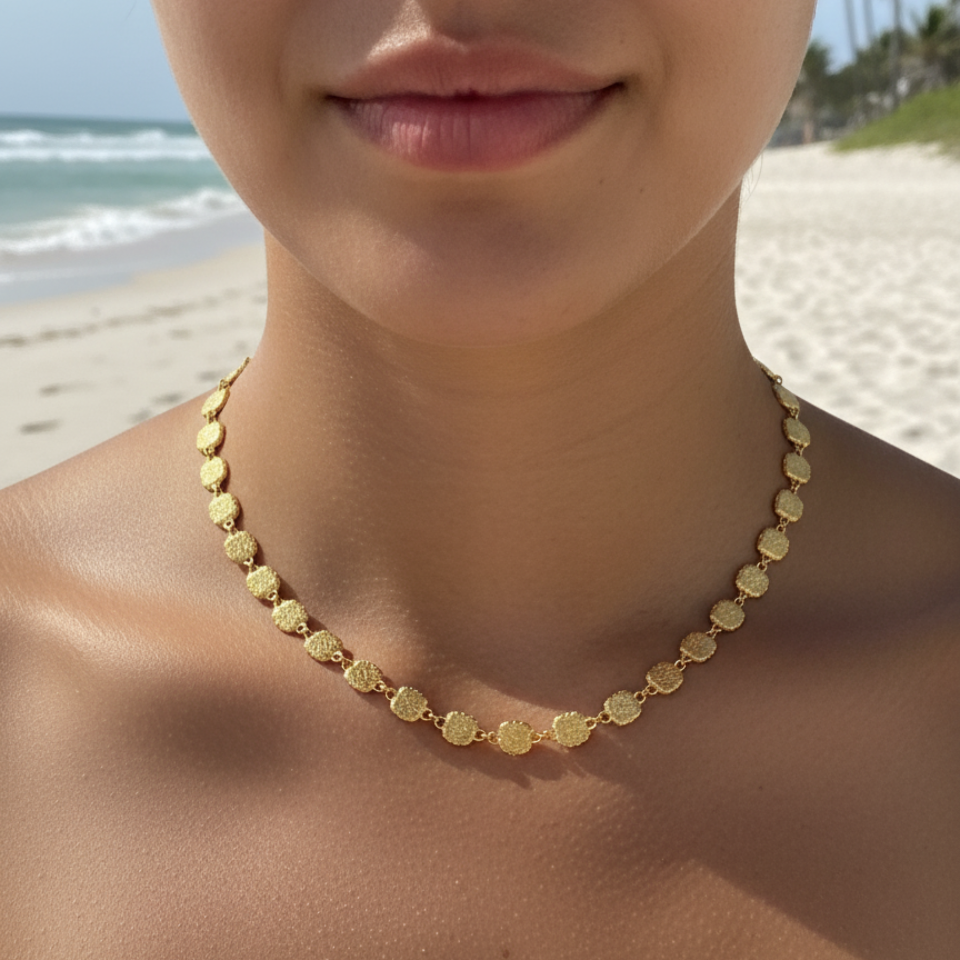 Gold textured square link chain necklace featuring small engraved square links connected in a continuous gold pattern.