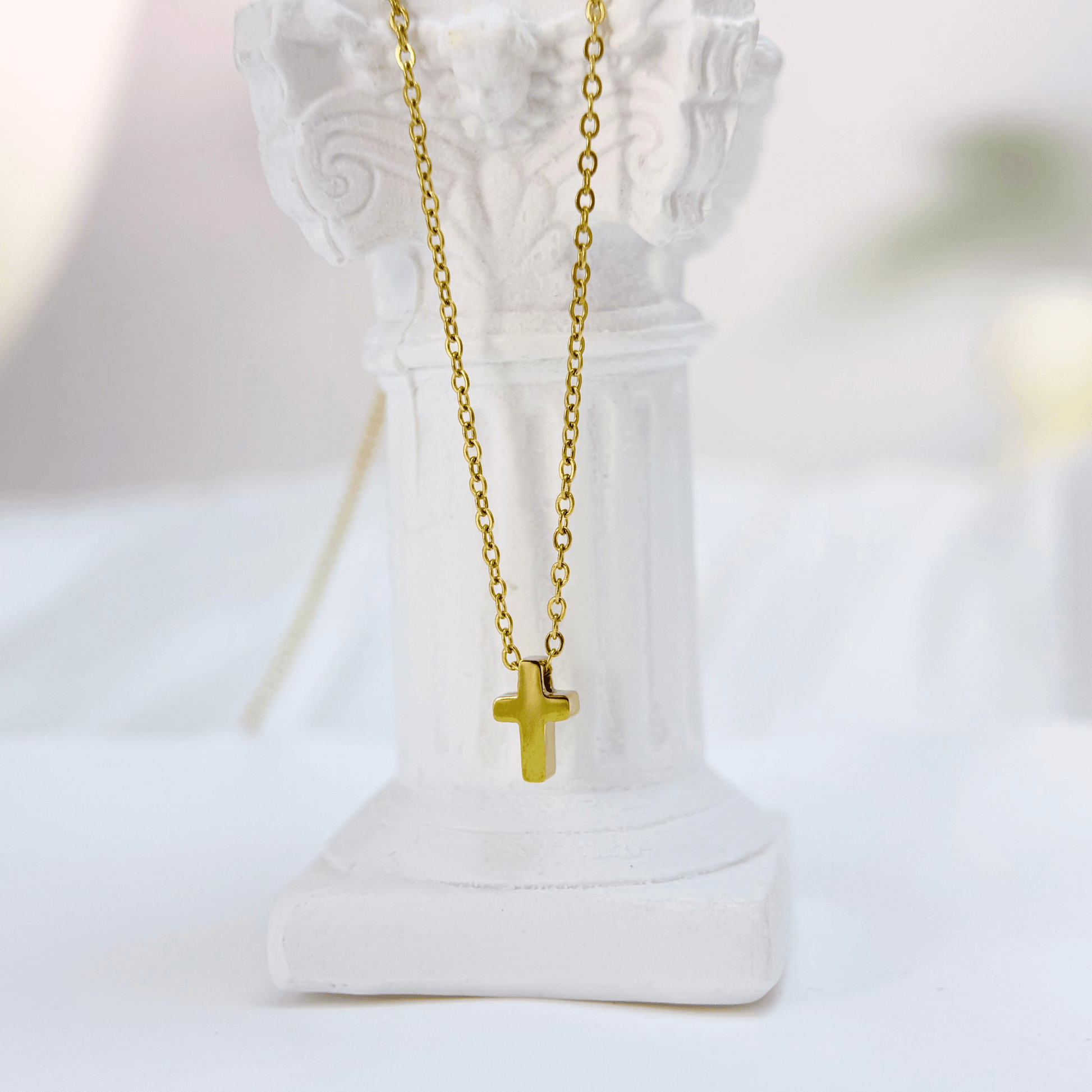 Gold tiny cross necklace symbolising faith and grace – MXW Jewellery
