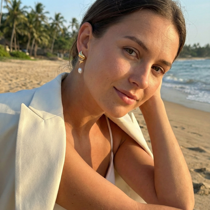 Gold twisted swirl pearl drop earrings displayed on a white bust, minimalist Australian design by MXW Jewellery