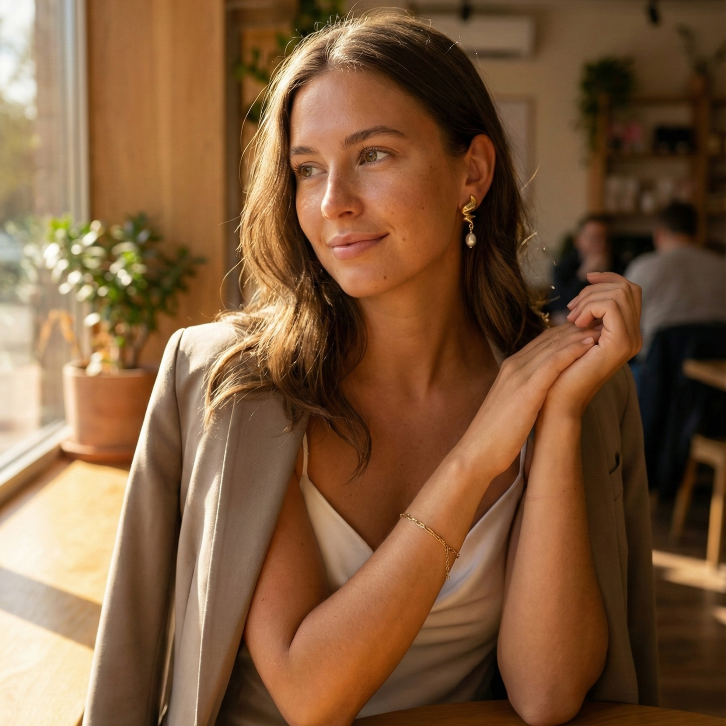 Gold twisted swirl pearl drop earrings displayed on a white bust, minimalist Australian design by MXW Jewellery
