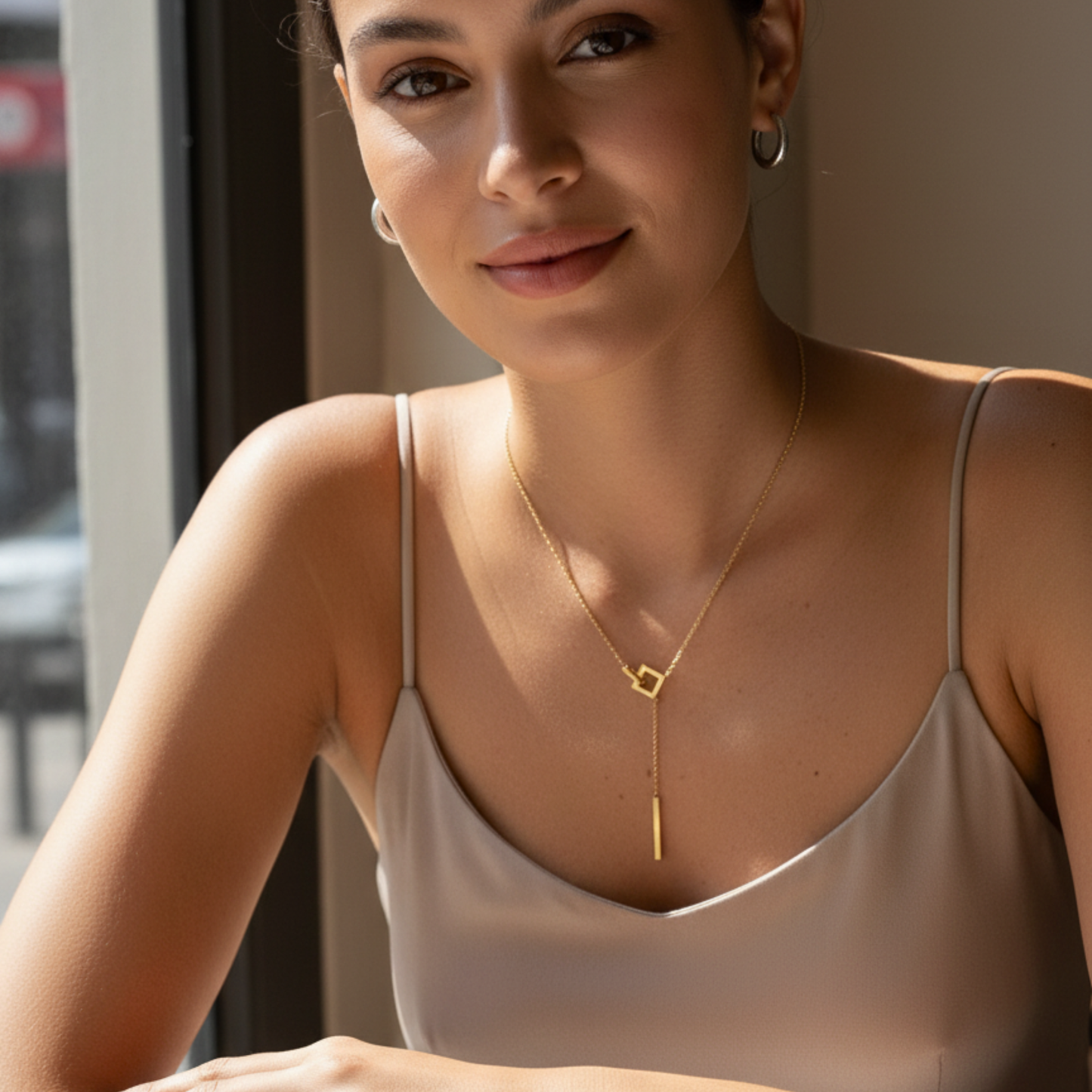 gold unity link necklace with interlocking geometric shapes symbolising connection and strength