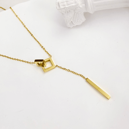 gold unity link necklace with interlocking geometric shapes symbolising connection and strength