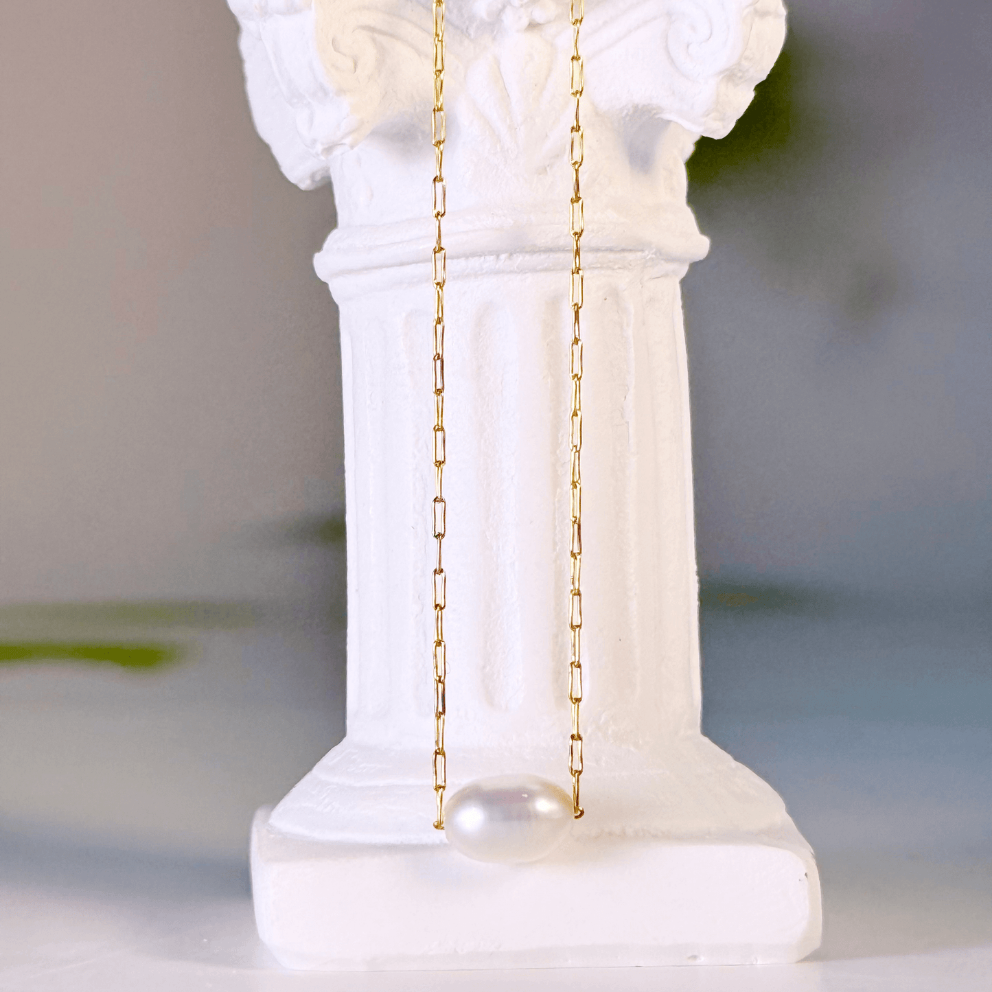 Dainty gold chain necklace with single freshwater pearl, minimalist waterproof design for layering or everyday wear.