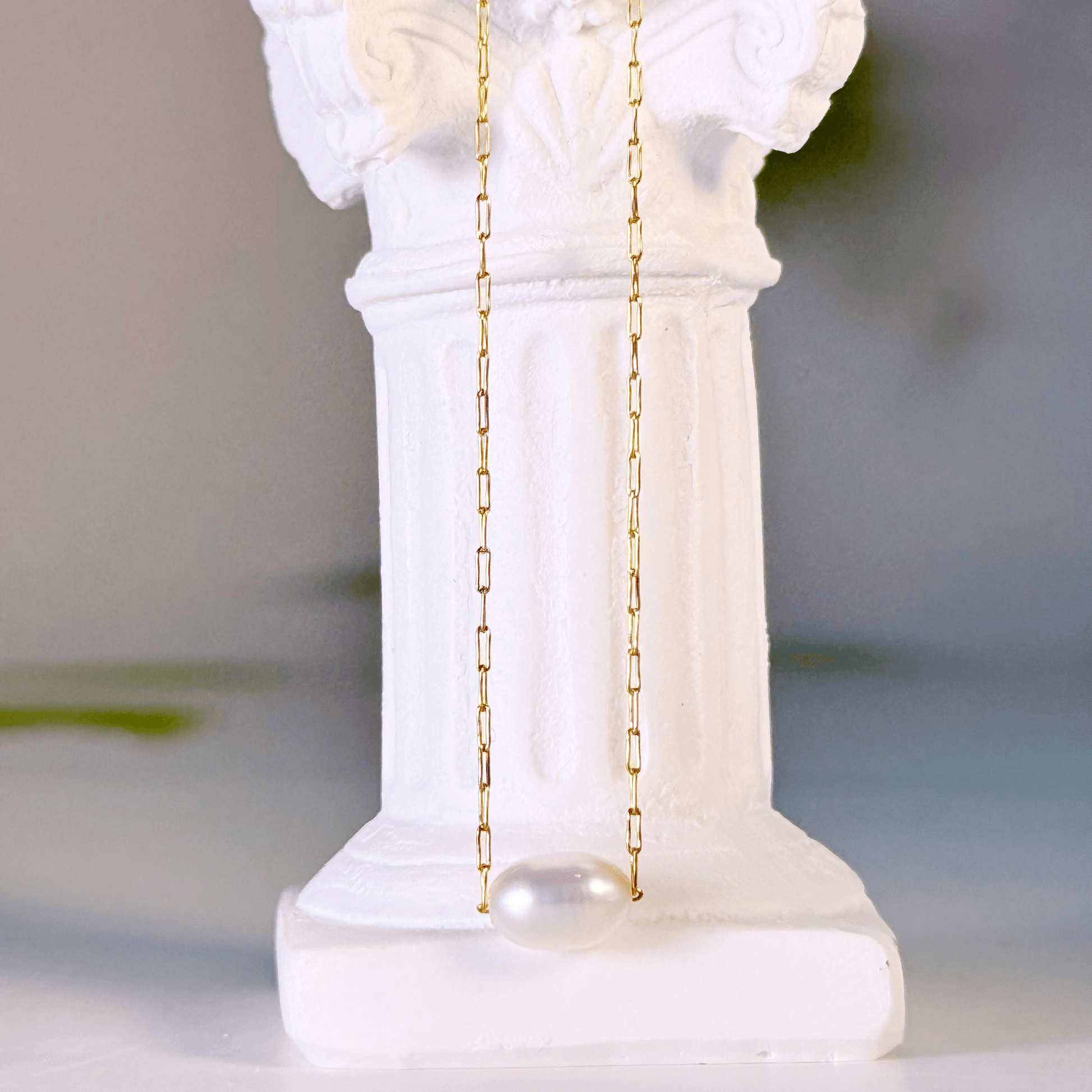 Dainty gold chain necklace with single freshwater pearl, minimalist waterproof design for layering or everyday wear.