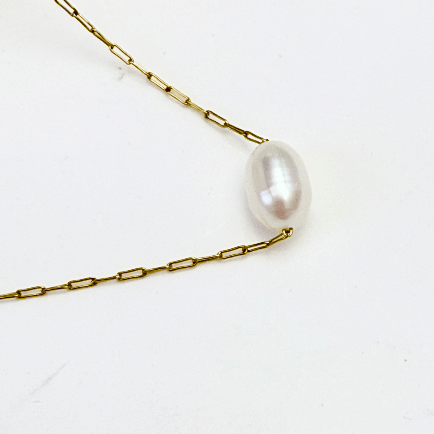 Dainty gold chain necklace with single freshwater pearl, minimalist waterproof design for layering or everyday wear.