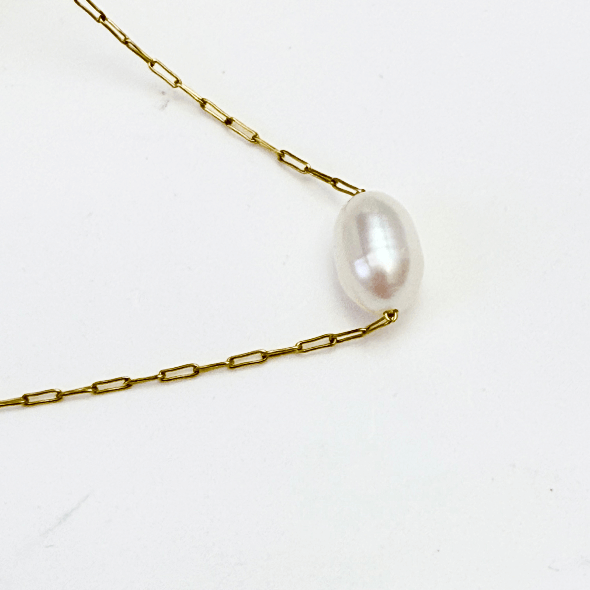 Dainty gold chain necklace with single freshwater pearl, minimalist waterproof design for layering or everyday wear.