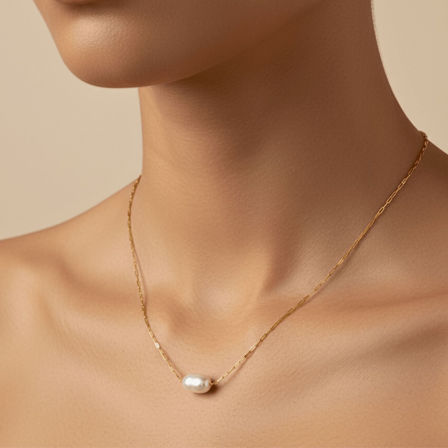 Dainty gold chain necklace with single freshwater pearl, minimalist waterproof design for layering or everyday wear.