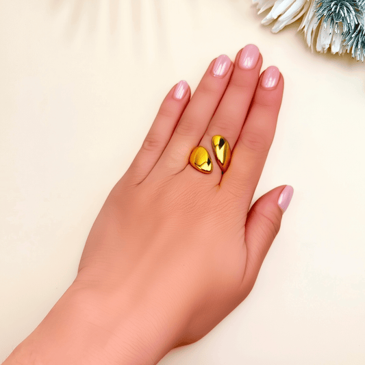 Golden Flame Ring featuring twin sculpted teardrop shapes in high-shine gold. Adjustable, waterproof, and tarnish-resistant stainless steel ring with bold open design.