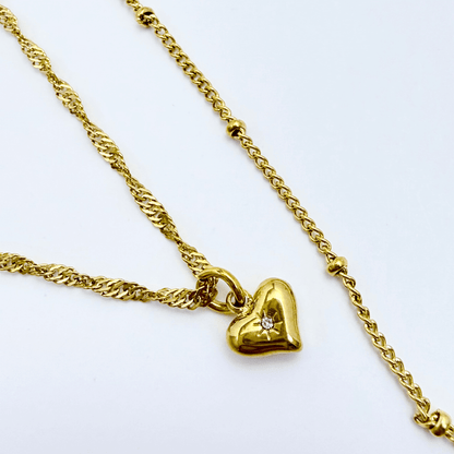 Gold double-layer necklace with heart charm and mandala pendant