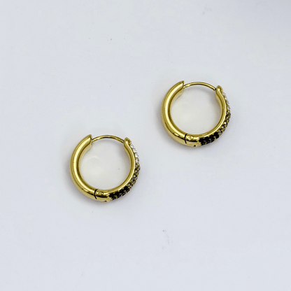 Gradient black pavé gold huggie earrings with ombré crystals.