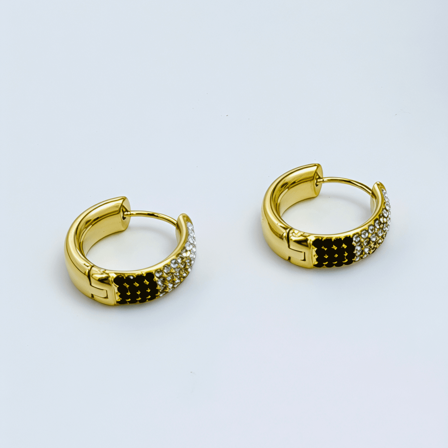 Gradient black pavé gold huggie earrings with ombré crystals.