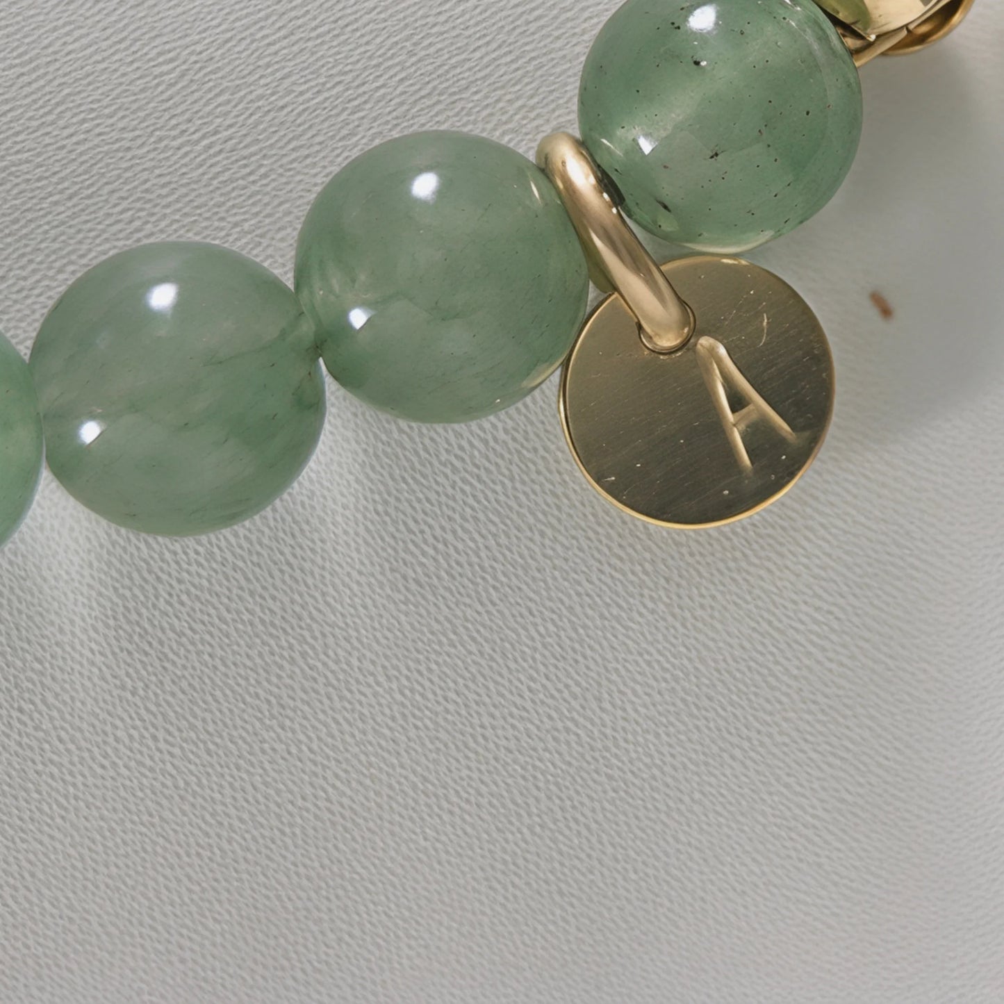 Green aventurine, pearl and initial gold bracelet featuring polished green gemstone beads, lustrous freshwater pearls and a personalised gold-filled stamped initial disc.